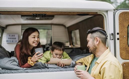 Family of three lounging in their RV